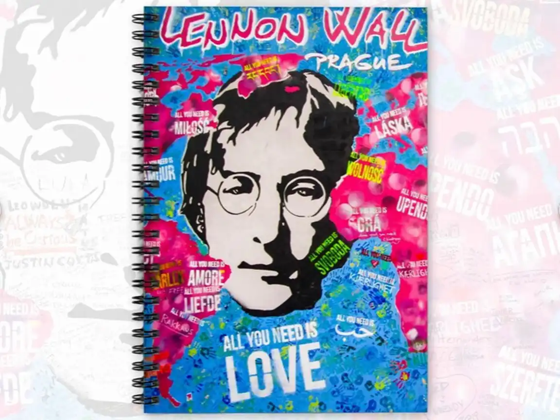 Spiral notebook featuring vibrant graffiti art from Prague's John Lennon Wall, perfect for Beatles fans, street art enthusiasts, and travelers. Durable 350 gsm cover with 118 ruled pages for journaling or note-taking.